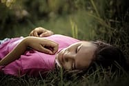 girl lying on grass