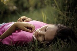 girl lying on grass